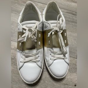 Valentino studded gold and white sneakers .“open sneakers with metallic stripe”